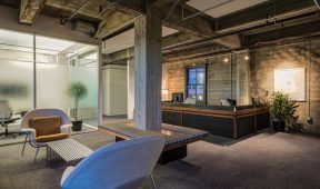 A modern office reception area featuring comfortable chairs and a welcoming atmosphere for visitors.