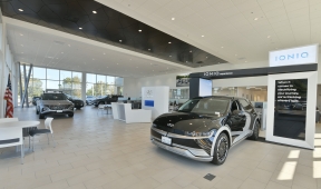 Car dealership showroom with  vehicles on display.