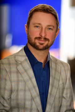 A well-dressed man, Samuel B. Keehn, wearing a suit and blue shirt, embodies professionalism and elegance.