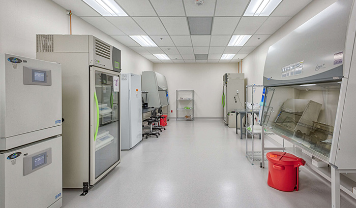 A lab with a refrigerator and scientific equipment for research